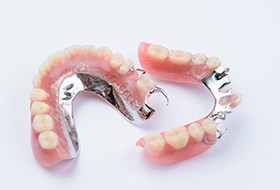 2 arches of partial dentures on a white surface